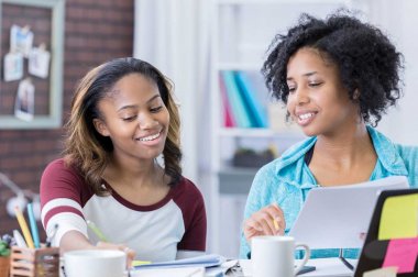 Two young women working on homework