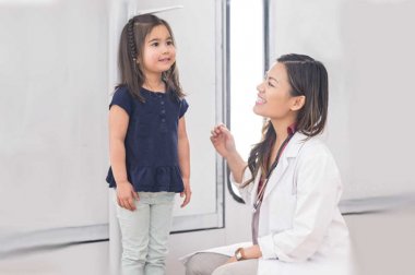 Doctor measuring height of small child