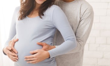 A man hugging his pregnant wife