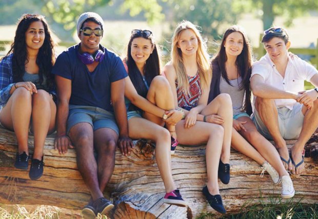 Group of teens sitting outside together