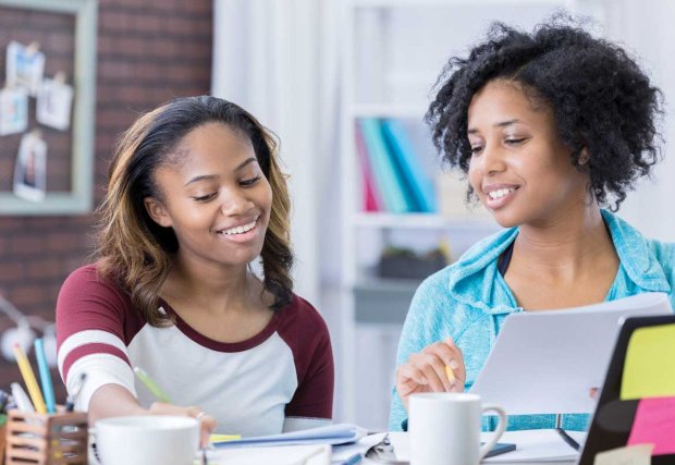 Two young women working on homework