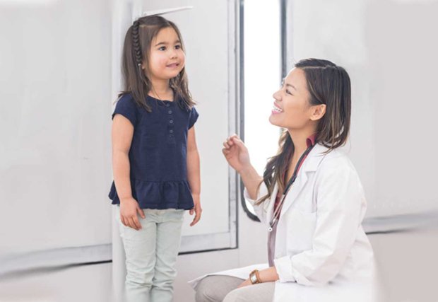 Doctor measuring height of small child