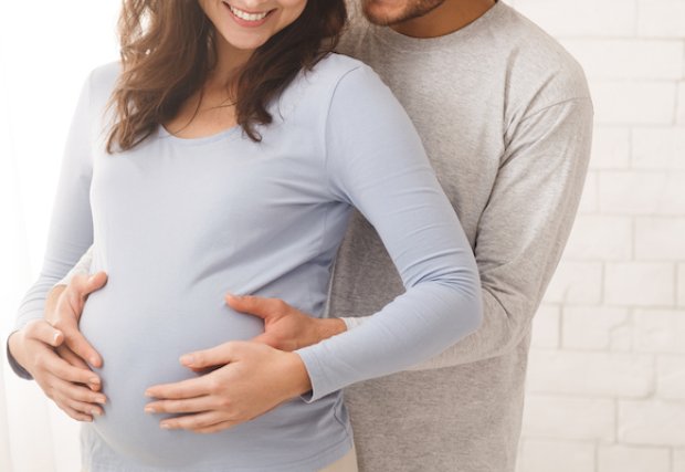 A man hugging his pregnant wife