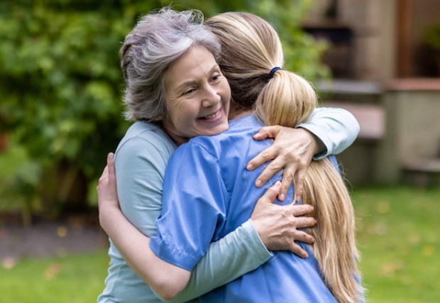 An older woman and younger woman hugging each other